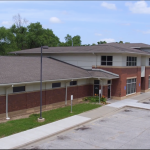 Exterior of PHC’s East Des Moines clinic, with a sign reading “Medicaid Accepted at PHC East Side Clinic.”
