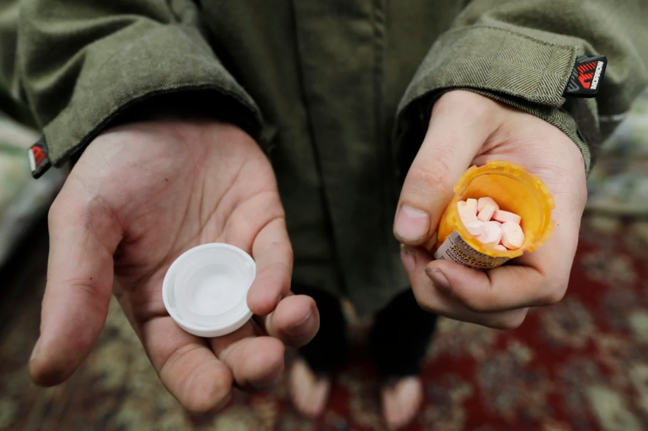 Man holding a prescription pill bottle.