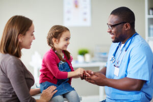 Cute child and doctor talking in clinics